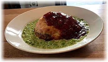 meat pie served atop mushy peas